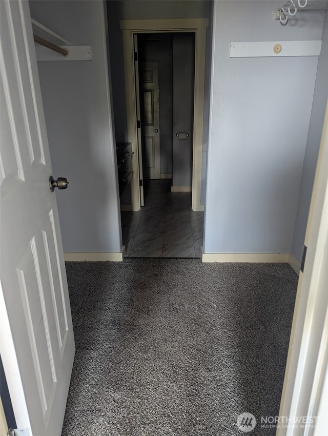 hallway featuring baseboards