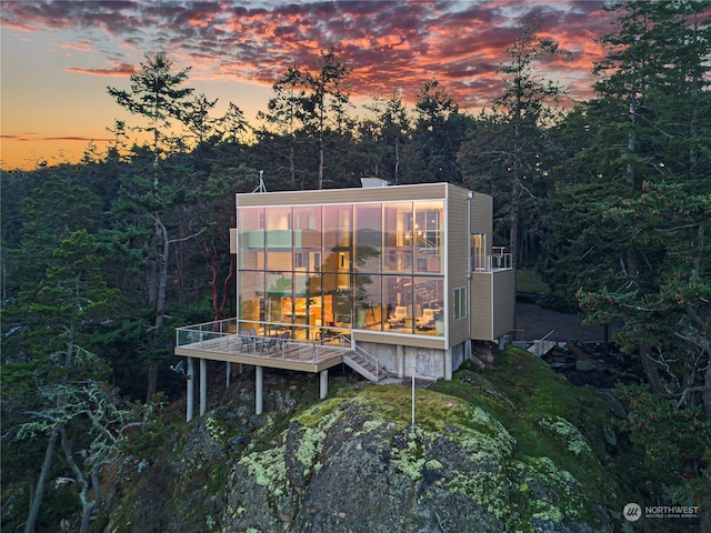 view of back house at dusk