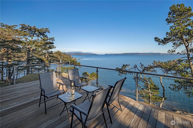 deck with a water and mountain view