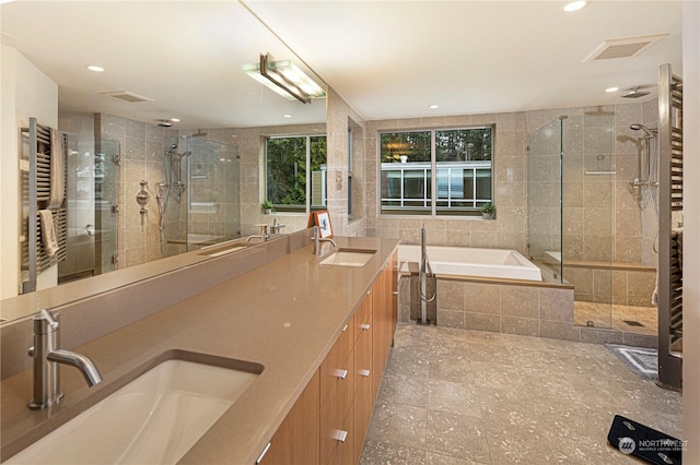 bathroom featuring separate shower and tub, vanity, and radiator