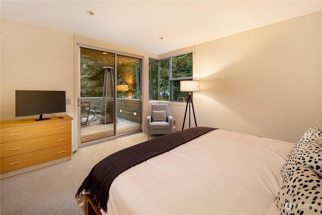 bedroom featuring light carpet and access to exterior