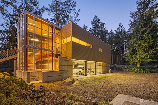 view of back house at dusk