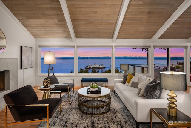 living room with vaulted ceiling with beams, a water view, wood ceiling, a fireplace, and hardwood / wood-style floors