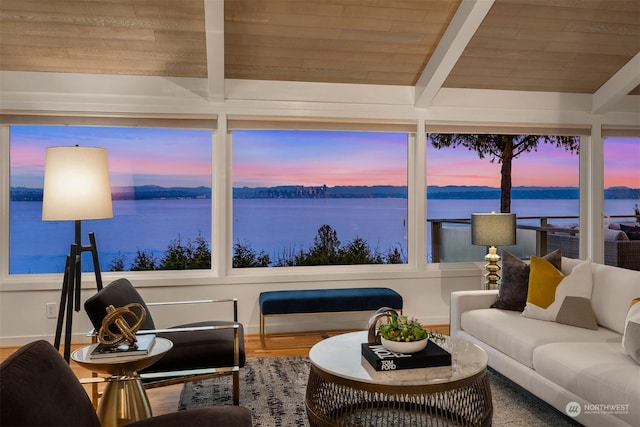 sunroom / solarium featuring a water view, wooden ceiling, and beamed ceiling