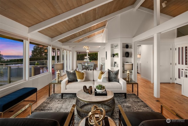 sunroom / solarium featuring plenty of natural light and vaulted ceiling with beams