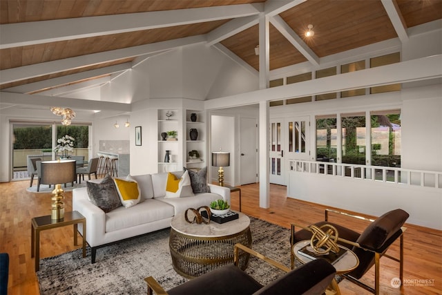 living room with high vaulted ceiling, beamed ceiling, hardwood / wood-style flooring, wooden ceiling, and an inviting chandelier