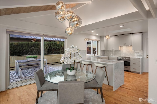 dining space featuring sink and light hardwood / wood-style flooring