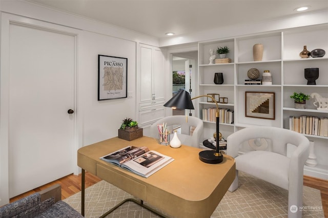 office area with crown molding and light hardwood / wood-style floors