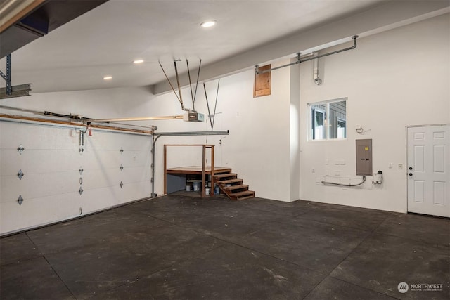 garage featuring a garage door opener and electric panel