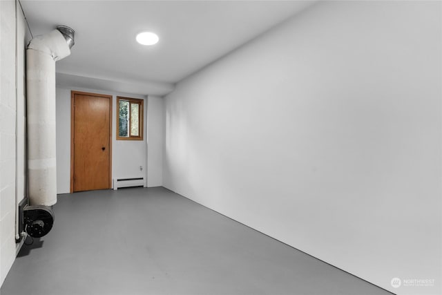 spare room with a baseboard radiator and concrete floors