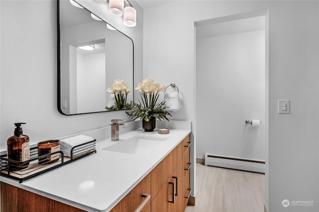 bathroom with vanity and a baseboard radiator