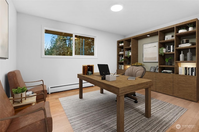 home office featuring a baseboard radiator and light hardwood / wood-style flooring