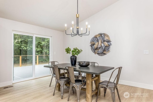 dining area featuring an inviting chandelier and light wood-type flooring