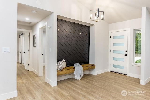 mudroom with light wood-type flooring and an inviting chandelier