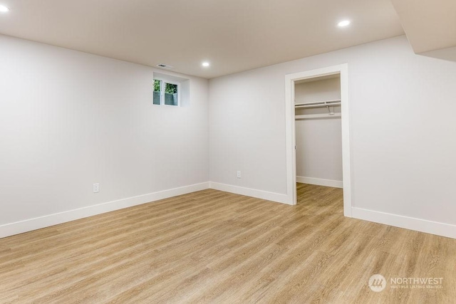 unfurnished bedroom with a walk in closet and a closet