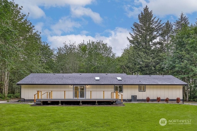 back of house with a lawn, central AC, and a wooden deck