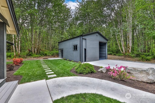 view of outdoor structure with a garage and a yard