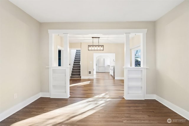 spare room with dark wood-type flooring