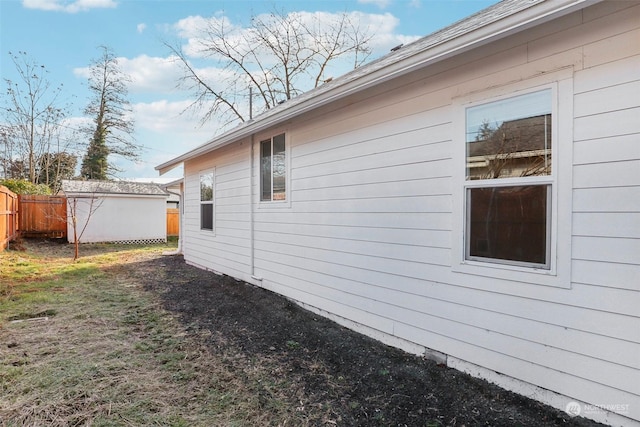 view of side of home with a storage unit