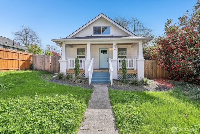 bungalow-style home featuring a porch and fence
