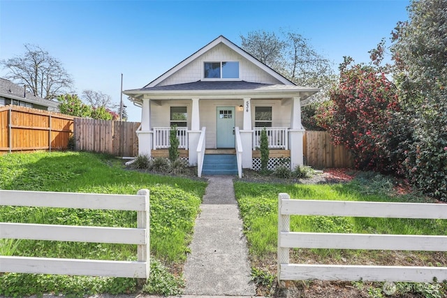 bungalow with a porch and fence