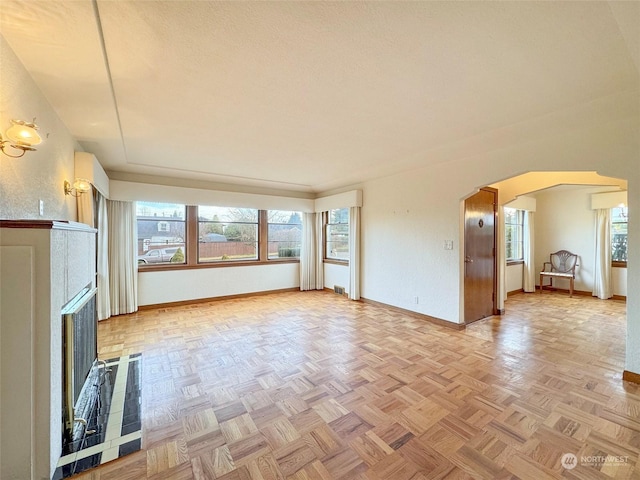 unfurnished living room with light parquet floors