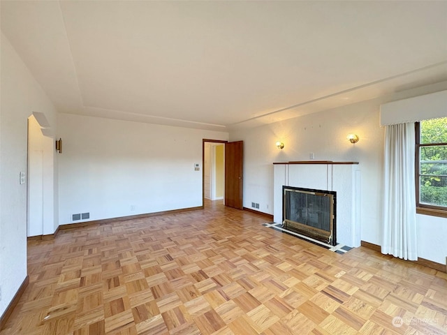 unfurnished living room featuring light parquet flooring