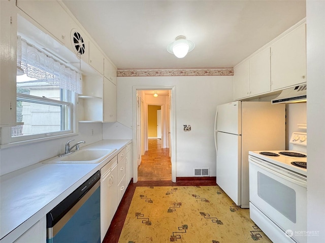 kitchen featuring white cabinetry, sink, and white appliances