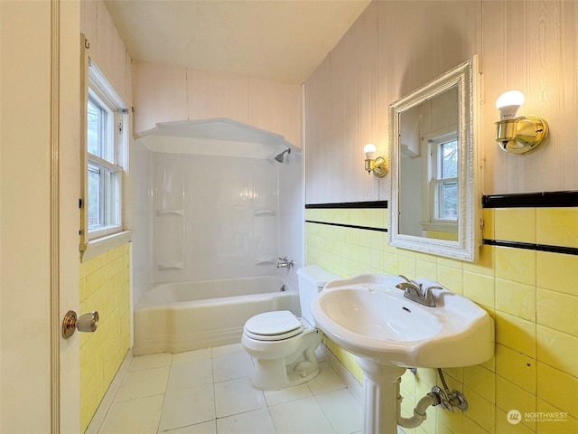 full bathroom with tile patterned floors, shower / washtub combination, toilet, and a wealth of natural light