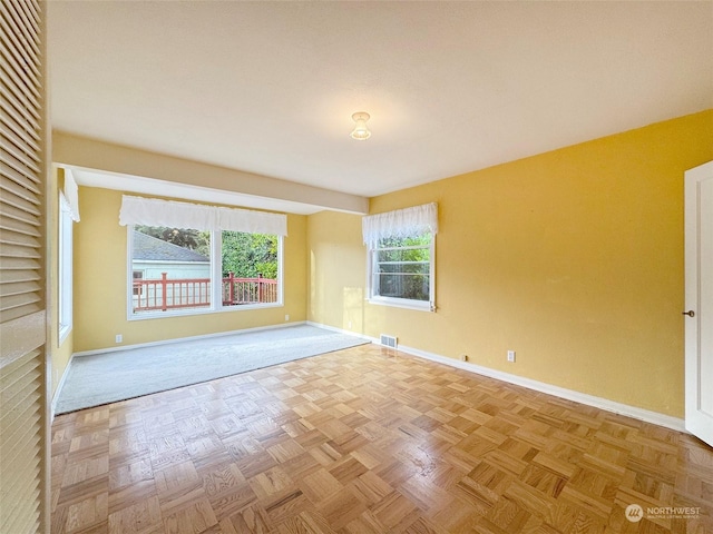 unfurnished room with light parquet flooring