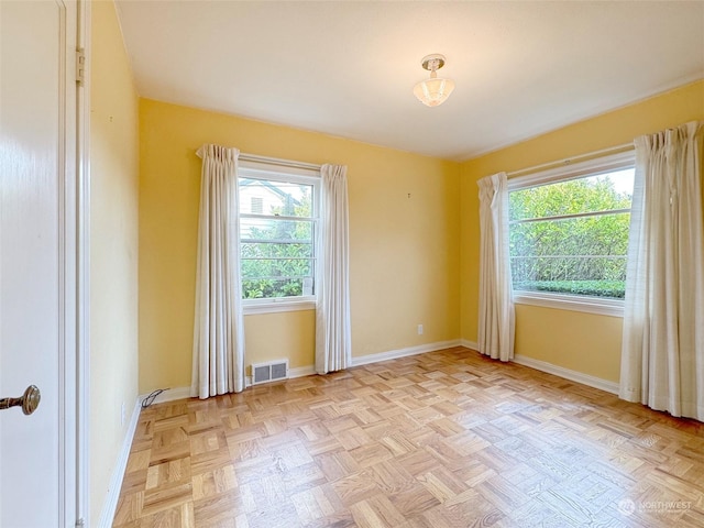 spare room with light parquet flooring