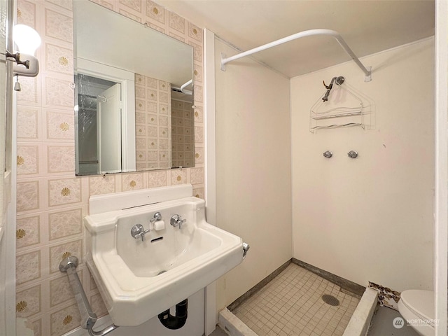 bathroom with sink, toilet, tile patterned flooring, and a shower