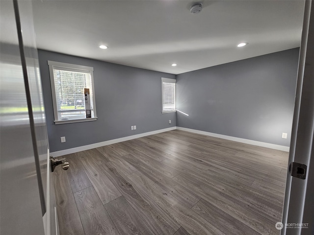 unfurnished room with hardwood / wood-style floors