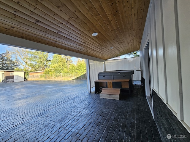 wooden terrace with a hot tub