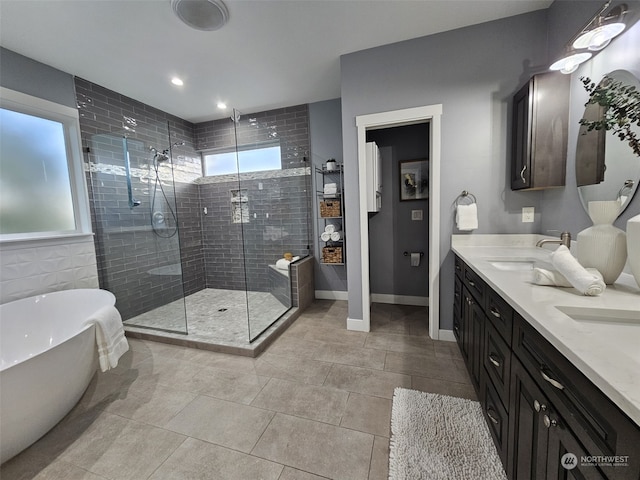 bathroom with vanity and shower with separate bathtub