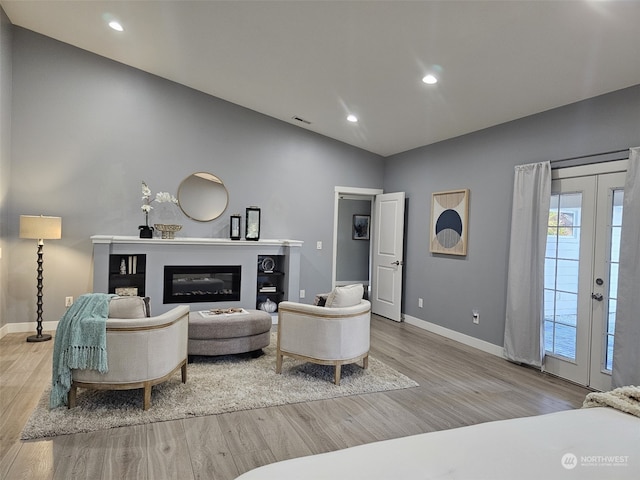 living room with french doors and light hardwood / wood-style flooring