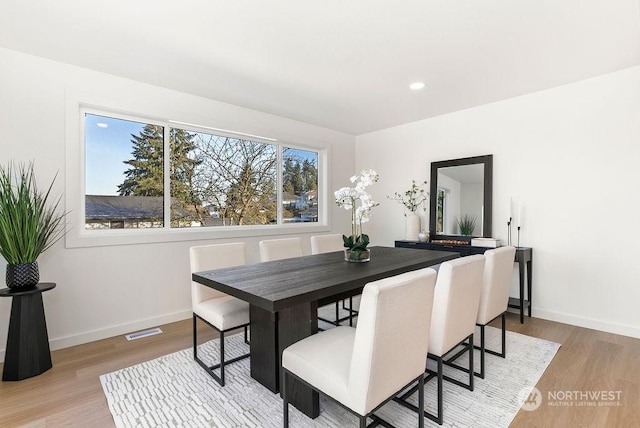 dining space with light hardwood / wood-style flooring