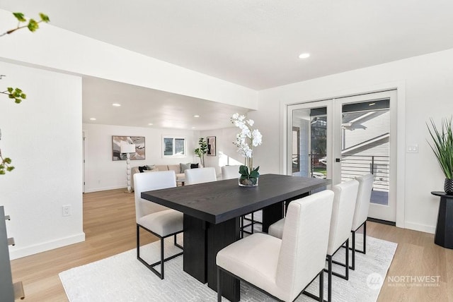 dining space featuring french doors and light hardwood / wood-style flooring