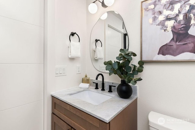 bathroom featuring vanity and toilet