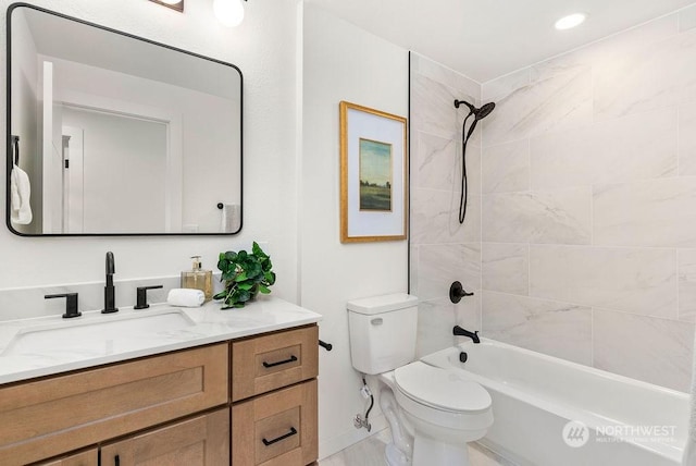 full bathroom featuring vanity, toilet, and tiled shower / bath