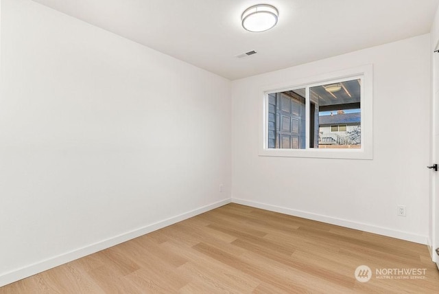 spare room featuring light wood-type flooring