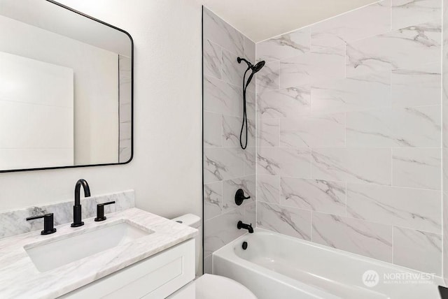 full bathroom featuring vanity, toilet, and tiled shower / bath