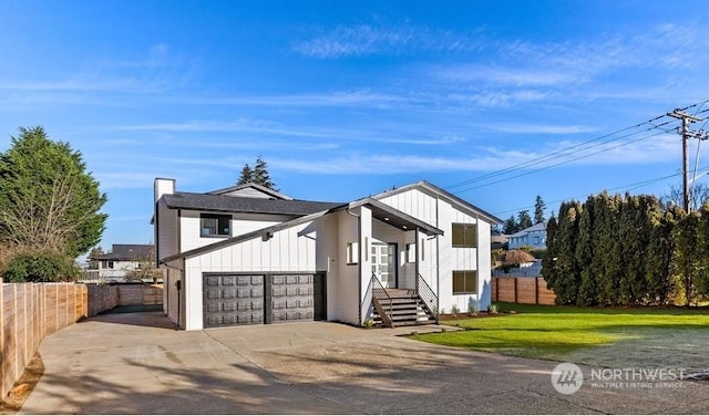 view of front of home featuring a garage and a front lawn