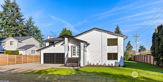 view of front of home featuring a garage and a front lawn