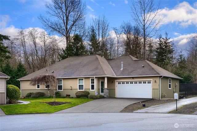 view of front of house with a garage and a front yard