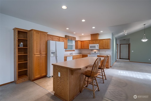 kitchen featuring white appliances, a center island, light carpet, and hanging light fixtures