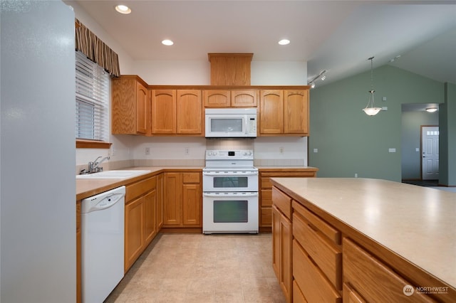 kitchen with sink, decorative light fixtures, white appliances, and lofted ceiling