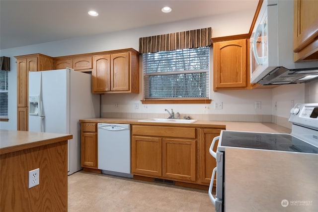 kitchen with sink and white appliances