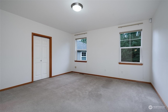 unfurnished room with light carpet