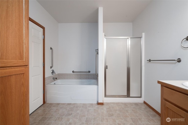 bathroom with vanity and shower with separate bathtub